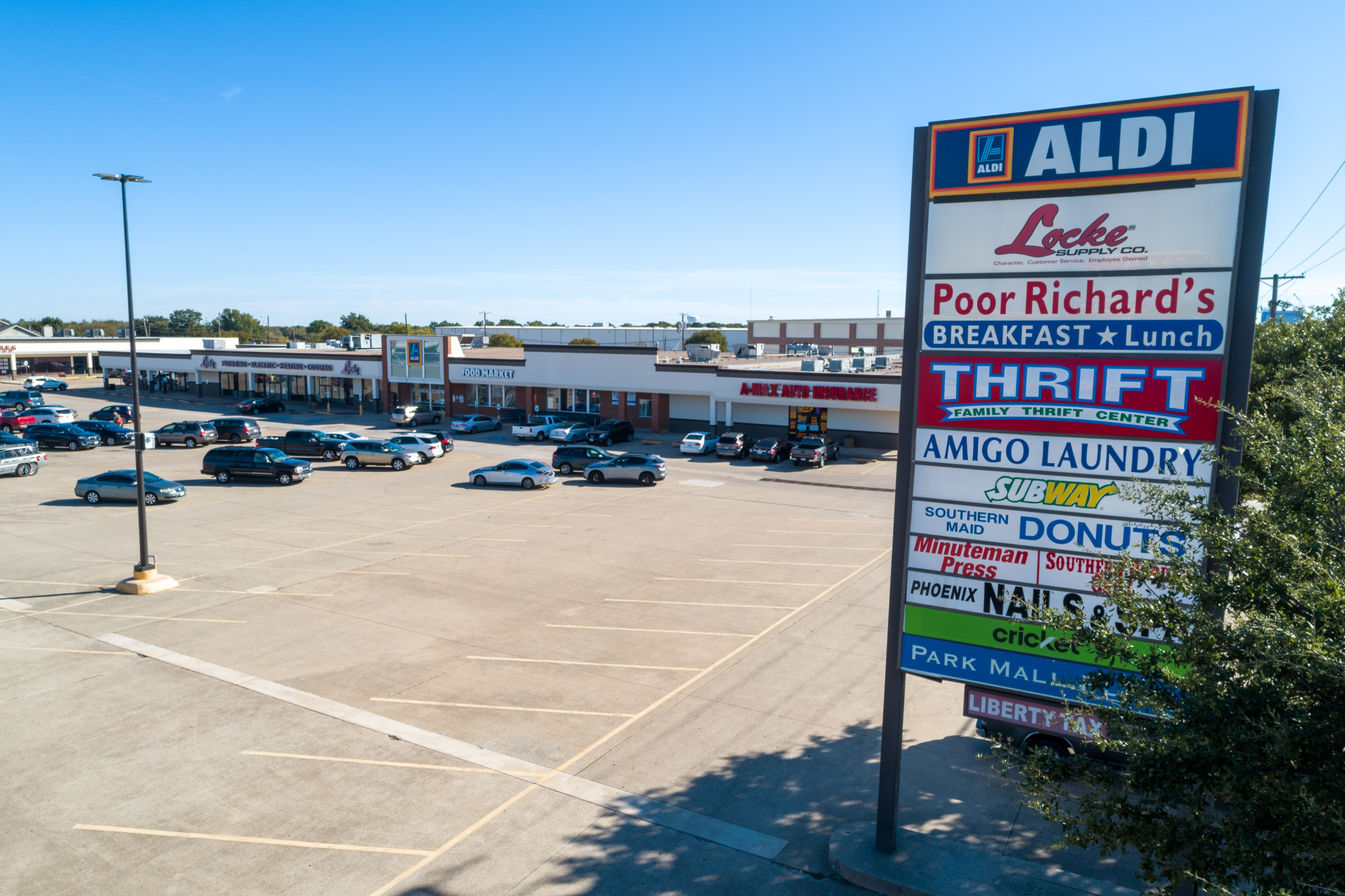 Commercial aerial drone photography of a vibrant retail plaza in DFW.
